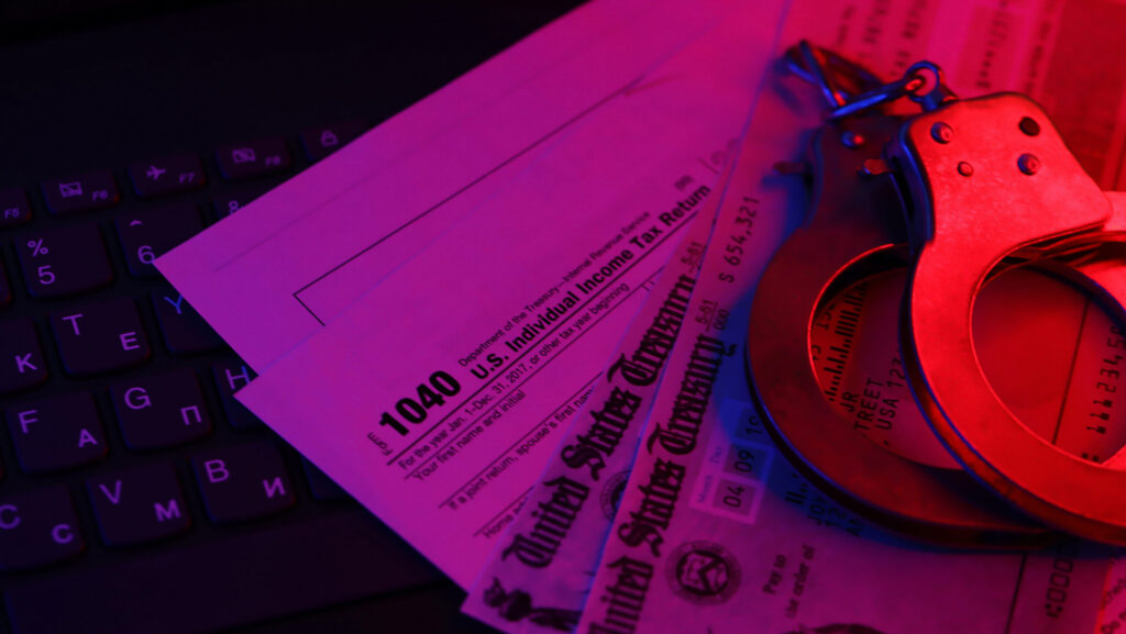 us tax refund check and handcuffs on computer keyb 2024 07 29 18 57 23 utc scaled e1731919888686